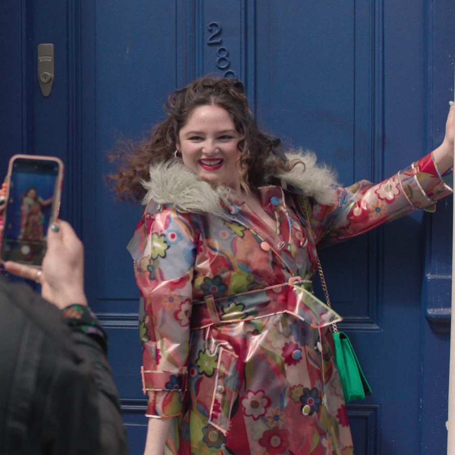 Megan Stalter as Jessica in a floral, fur-collared trench coat by Celia B