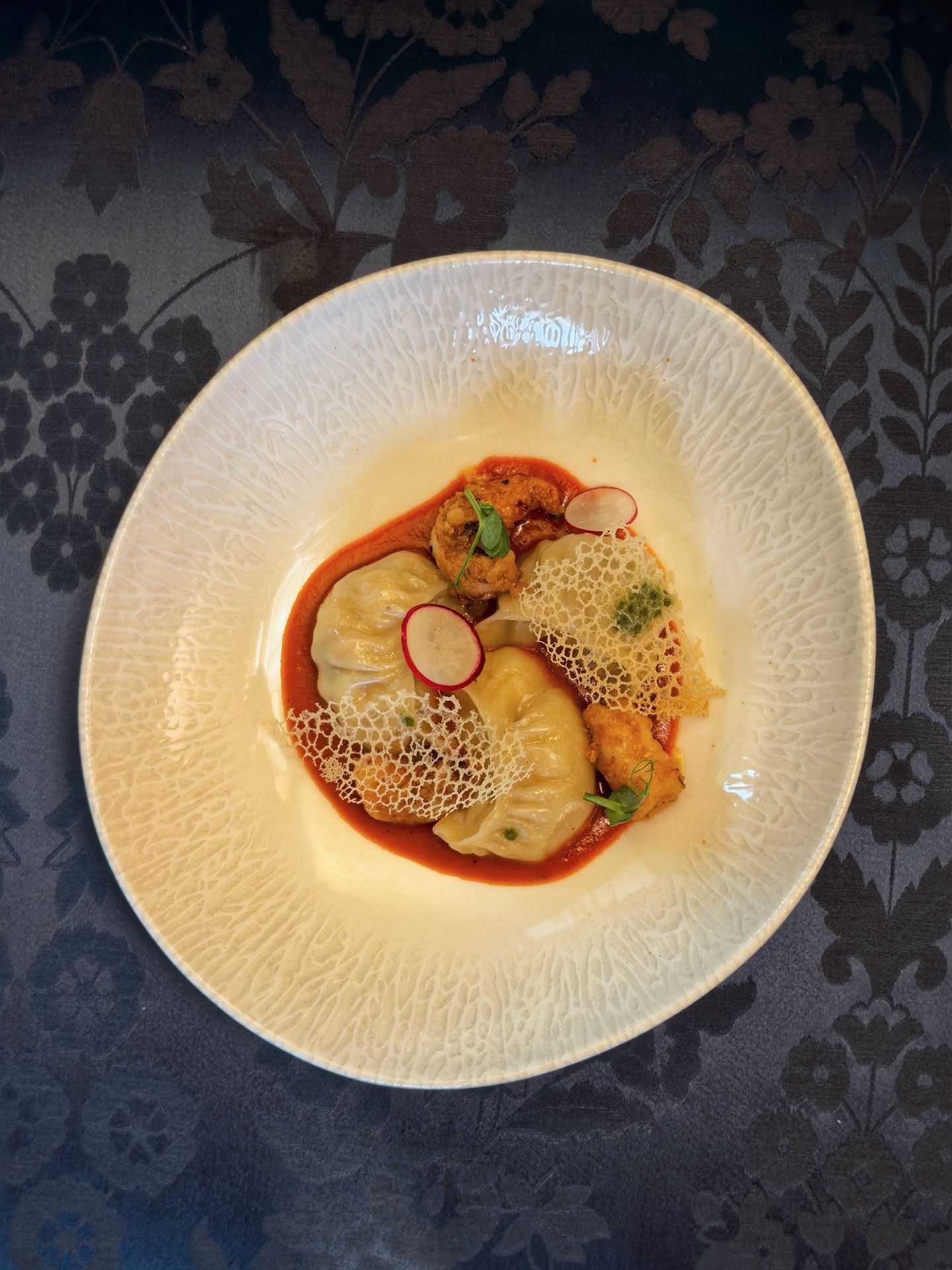 Jhol Momo with roasted tomato chutney and prawns