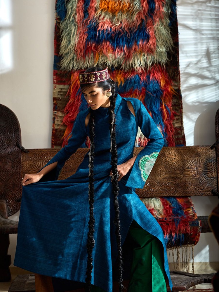 19th-century hirsute textile from the Taurus highlands featuring quadrilateral flame motifs hinting at Zoroastrian cosmology used as a sleeping bag by pastoralists. On Anika: Payal Khandwala kurta; Kutchi waist-belt as a tiara; Pepper Coin jewellery