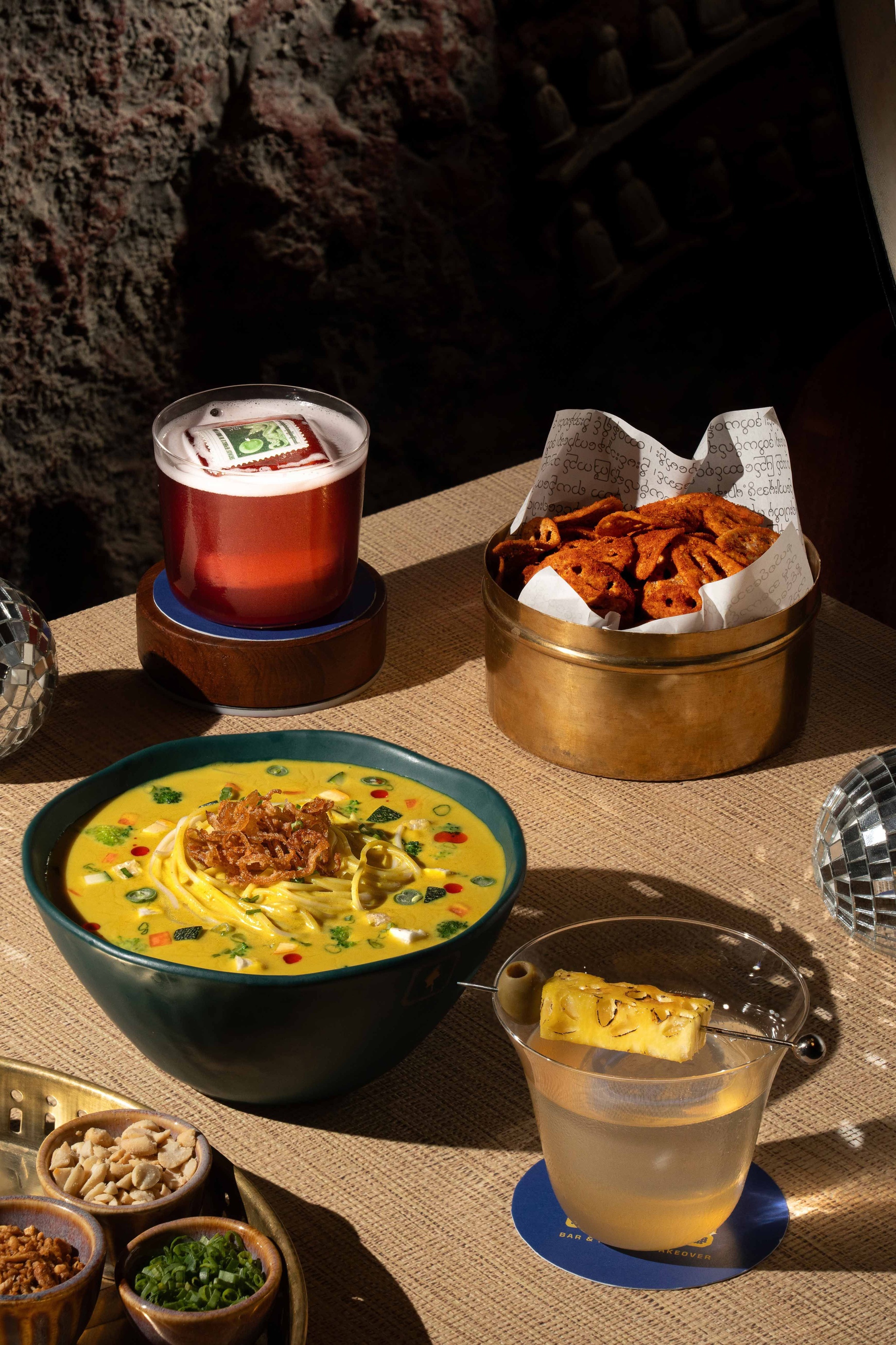 Iconic khowsuey with zero-proof jackfruit and pineapple rich cocktail Burma Sour
