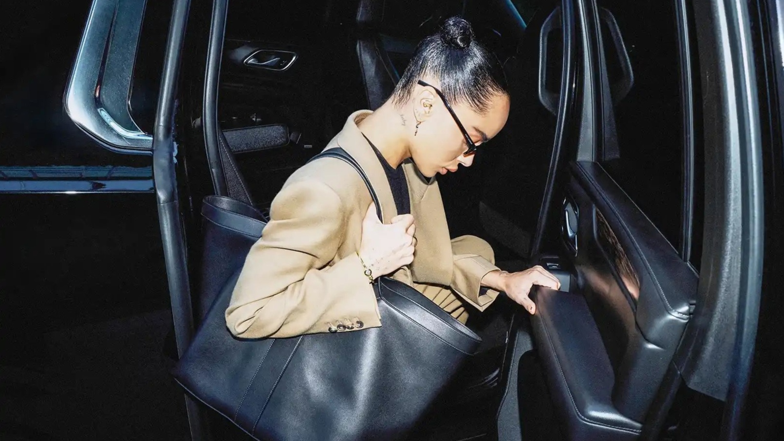Zoe Kravitz carrying a black YSL tote bag
