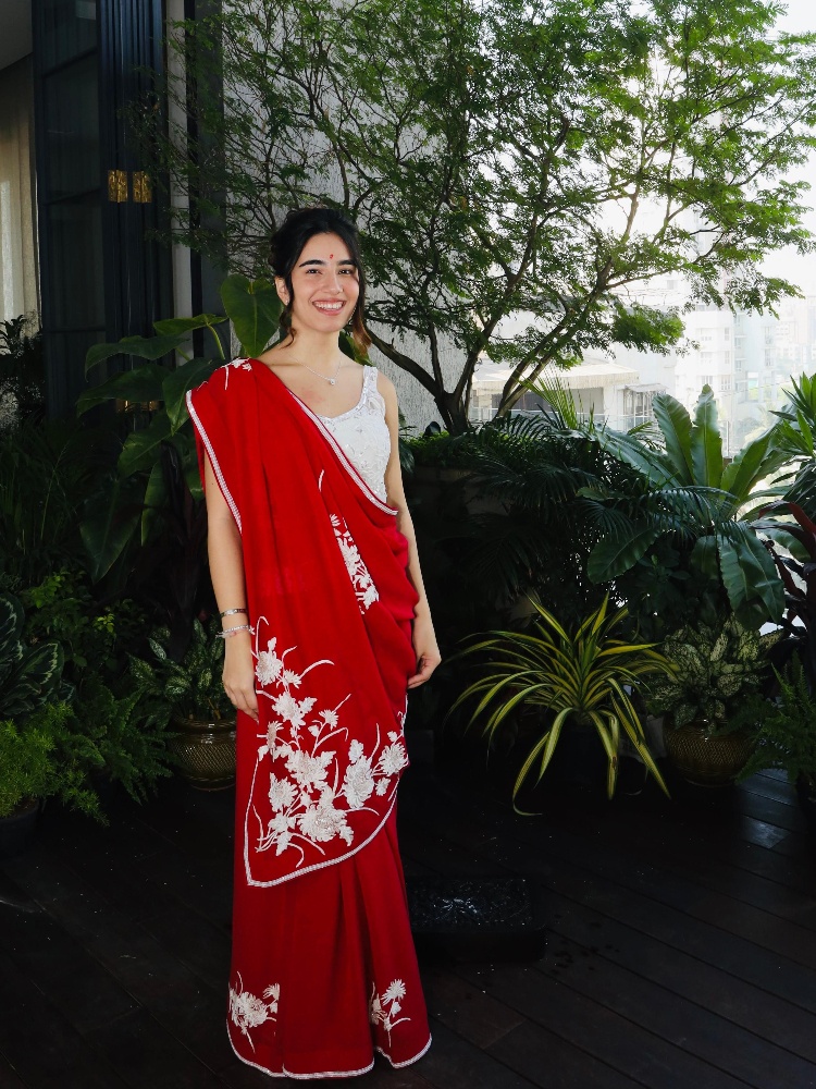 Zyra Nargolwala, a Gen Z Ashdeen client in a red sari featuring Parsi gara embroidery
