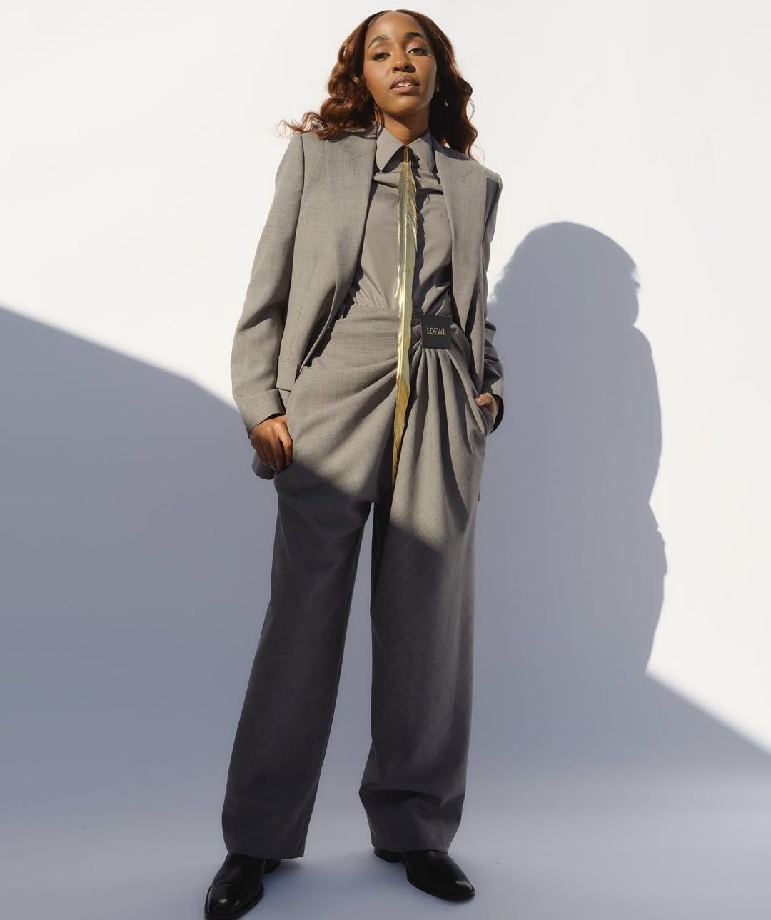 Ayo Edibiri in a custom grey suit by Loewe's Jonathan Anderson for the 2025 Golden Globes. Styled by Danielle Goldberg.