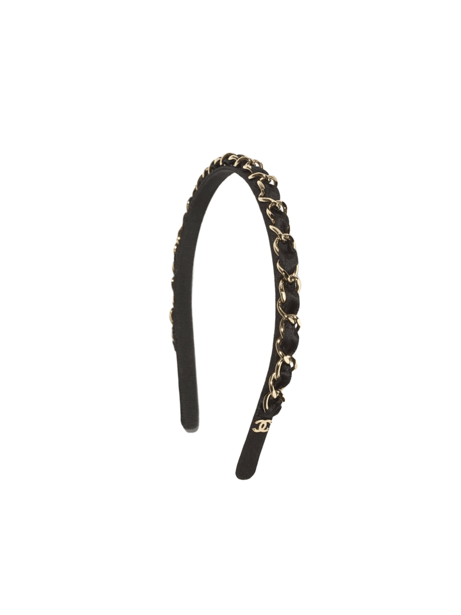 A black Chanel headband with light gold metal detail