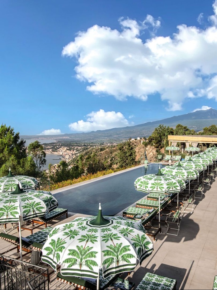 Dolce and Gabbana palme motifs dress the poolside at San Domenico Palace, Sicily