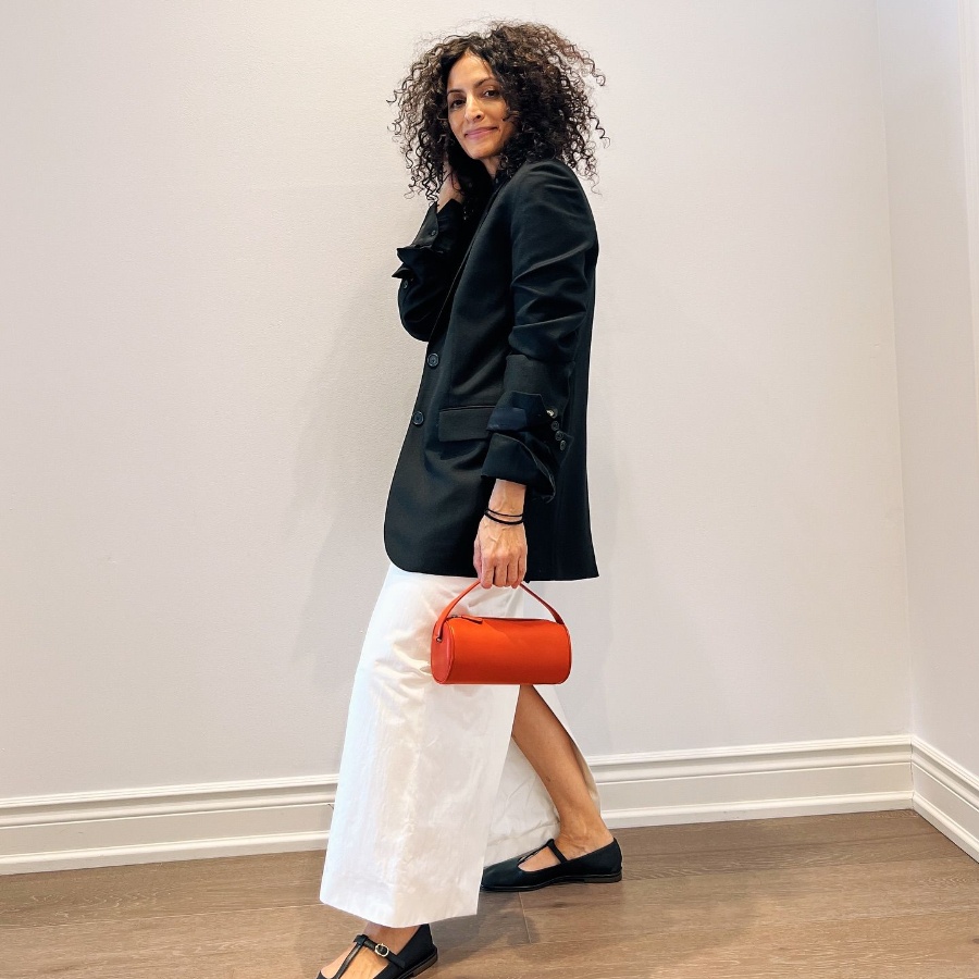 Neelam Ahooja in The Row’s Dustina blazer, T-Strap flats, and Round 90s bag