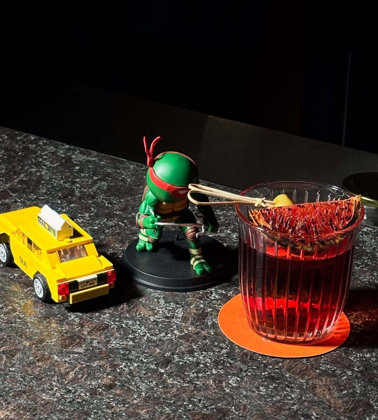 Yellow cab and Teenage Mutant Ninja Turtle figurines are NYC essentials alongside a Negroni
